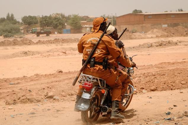 Local defense force fighters drive on a motorbike during an event to inaugurate a new chapter of the group in Ouagadougou, Burkina Faso, Saturday, March 14, 2020. In an effort to combat rising jihadist violence, Burkina Faso\\u2019s military has recruited volunteers to help it fight militants. (AP Photo/Sam Mednick)