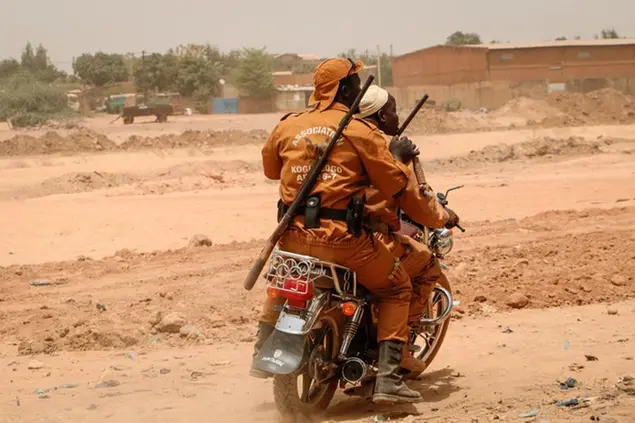 Local defense force fighters drive on a motorbike during an event to inaugurate a new chapter of the group in Ouagadougou, Burkina Faso, Saturday, March 14, 2020. In an effort to combat rising jihadist violence, Burkina Faso’s military has recruited volunteers to help it fight militants. (AP Photo/Sam Mednick)