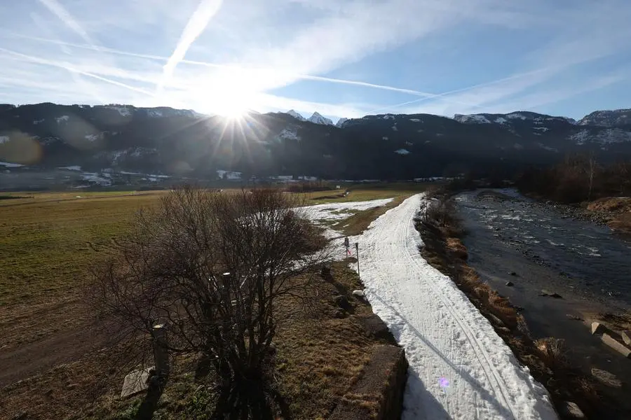 Sun rises over the mountains in Val di Fiemme, Predazzo, Italy, Saturday, Jan. 7, 2023. (AP Photo/Alessandro Trovati)