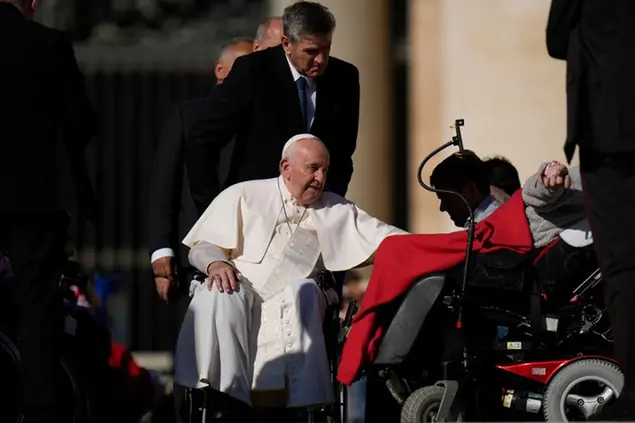 Pope Francis on a wheelchair reaches for people with disabilities during his weekly general audience in St. Pater's Square at The Vatican, Wednesday, Oct. 5, 2022. (AP Photo/Alessandra Tarantino)