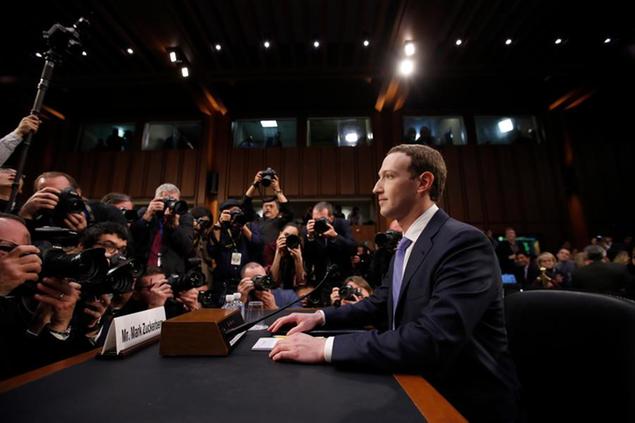 FILE - In this April 10, 2018, file photo, Facebook CEO Mark Zuckerberg takes his seat to testify before a joint hearing of the Commerce and Judiciary Committees on Capitol Hill in Washington. Reports of hateful and violent speech on Facebook poured in on the night of May 28 after President Donald Trump hit send on a social media post warning that looters who joined protests following Floyd's death last year would be shot, according to internal Facebook documents shared with The Associated Press. (AP Photo/Alex Brandon, File)