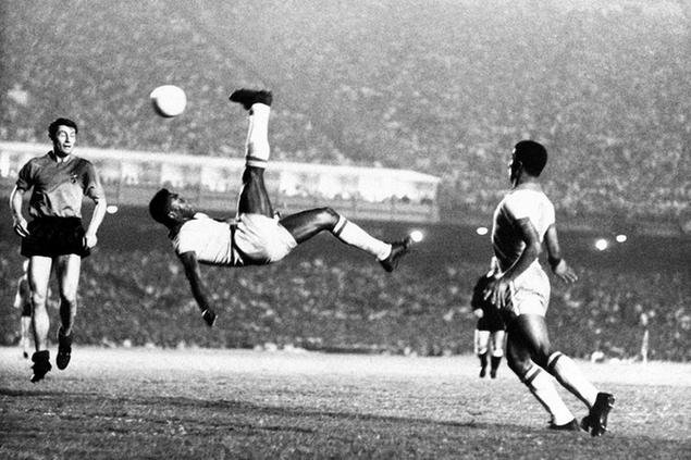 FILE - In this Sept. 1968 file photo, Brazil\\\\'s Pele kicks the ball during a friendly soccer game against Belgium in Rio de Janeiro, Brazil. On Oct. 23, 2020, the three-time World Cup winner Pel\\u00E9 turns 80 without a proper celebration amid the COVID-19 pandemic as he quarantines in his mansion in the beachfront city of Guaruj\\u00E1, where he has lived since the start of the pandemic. (AP Photo, File)