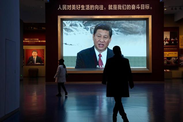 Chinese President Xi Jinping is seen on screen near the slogan \\\"The people's yearning for a better life is the goal we strive for\\\" at the Museum of the Communist Party of China here in Beijing, China, Friday, Nov. 12, 2021. Xi emerges from a party conclave this week not only more firmly ensconced in power than ever, but also with a stronger ideological and theoretical grasp on the ruling Communist Party's past, present and future. (AP Photo/Ng Han Guan)
