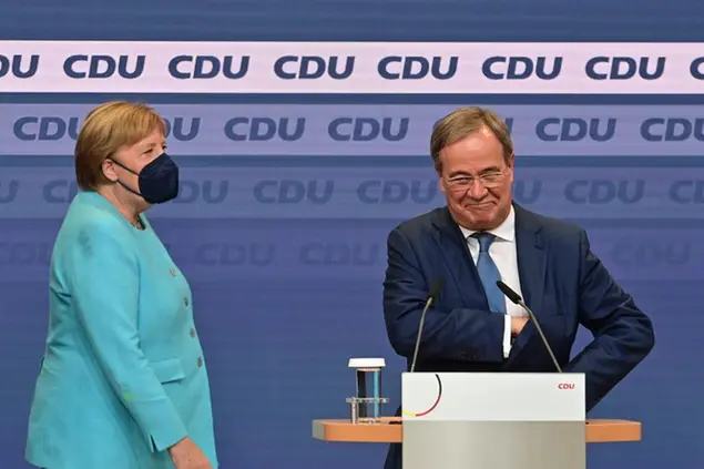 Chancellor Angela Merkel arrives to join on stage Armin Laschet, Federal Chairman of the CDU, top candidate of his party for Chancellor as he comments on the outcome of the Bundestag elections, at the Konrad Adenauer House, Berlin, Sunday, Sept. 26, 2021. Exit polls show the center-left Social Democrats in a very close race with outgoing Chancellor Angela Merkelâ€™s bloc in Germanyâ€™s parliamentary election, which will determine who succeeds the longtime leader after 16 years in power. (Peter Kneffel/DPA via AP)