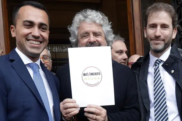 FILE - In this Friday, Jan. 19, 2018 file photo, 5-Star Movement founder Beppe Grillo, center, flanked by movement cofounder Davide Casaleggio, right, and lawmaker Luigi Di Maio pose in Rome. Italy's 5-Star Movement suffered a second blow in a week Friday after it split with Rousseau, the association that runs its \\\"direct democracy\\\" online platform allowing registered members to vote on key policy decisions. Rousseau is headed by Davide Casaleggio, whose father co-founded the 5-Star Movement along with comic Beppe Grillo. (AP Photo/Gregorio Borgia, File)