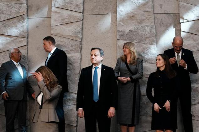 Italian Prime Minister Mario Draghi, center, waits for the start of a group photo opportunity during an extraordinary NATO summit at NATO headquarters in Brussels, Thursday, March 24, 2022. As the war in Ukraine grinds into a second month, President Joe Biden and Western allies are gathering to chart a path to ramp up pressure on Russian President Vladimir Putin while tending to the economic and security fallout that's spreading across Europe and the world. (AP Photo/Thibault Camus)