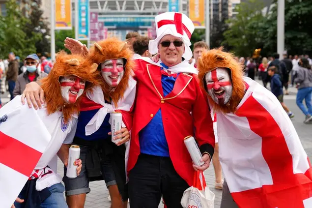 England fans dressed with lion costumes gather outside Wembley Stadium in London, Wednesday, July 7, 2021, ahead of the Euro 2020 soccer championship semifinal match between England and Denmark which will be played at Wembley. (AP Photo/Thanassis Stavrakis)