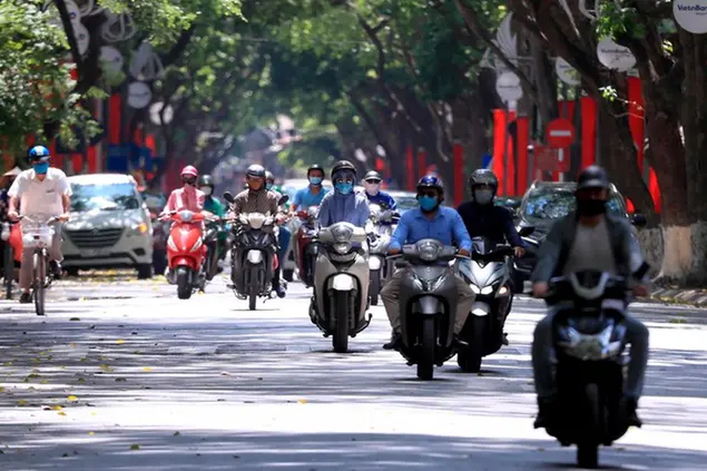 People ride motorcycles in Hanoi, Vietnam Monday, May 31, 2021. Vietnam plans to test all 9 million people in its largest city for the coronavirus and imposed more restrictions Monday to deal with a growing COVID-19 outbreak. (AP Photo/Hau Dinh)