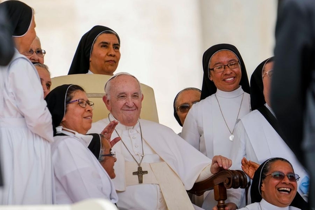 Pope Francis poses for a photo with nuns at the end of his weekly general audience in St. Peter's Square at the Vatican, Wednesday, June 22, 2022. (AP Photo/Andrew Medichini)