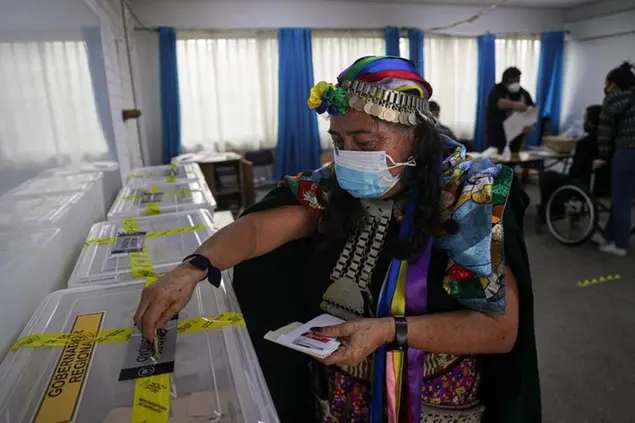 Indigenous Mapuche Constituent Assembly candidate Juana Millal, for the Partido del Pueblo, cast her vote at a polling station during the second day of the Constitutional Convention election to select assembly members that will draft a new constitution, in Santiago, Chile, Sunday, May 16, 2021. (AP Photo/Esteban Felix)