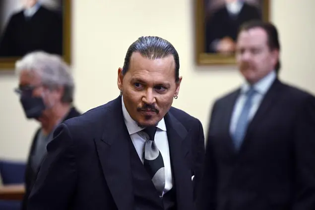 Actor Johnny Depp returns to the courtroom after a break at the Fairfax County Circuit Court in Fairfax, Va., Tuesday, April 26, 2022. Depp sued his ex-wife actress Amber Heard for libel in Fairfax County Circuit Court after she wrote an op-ed piece in The Washington Post in 2018 referring to herself as a \\\"public figure representing domestic abuse.\\\" (Brendan Smialowski/Pool Photo via AP)