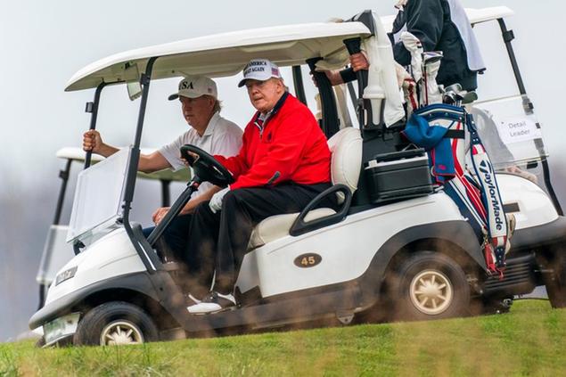President Donald Trump, dries his golf cart as he plays golf at the Trump National Golf Club in Sterling, Va., Saturday, Nov. 21, 2020. (AP Photo/Manuel Balce Ceneta)
