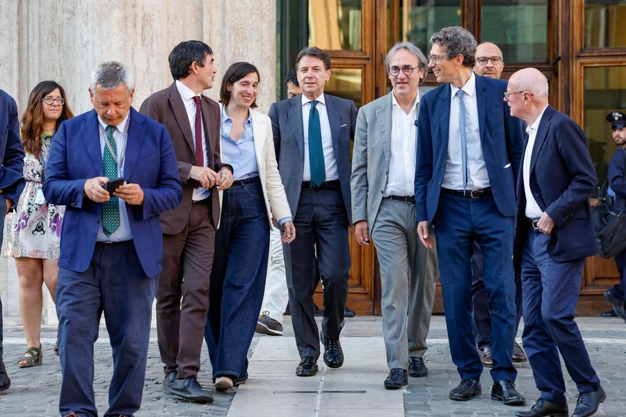 Un gruppo di persone discute su valori e politiche in un contesto di tensioni e diversità