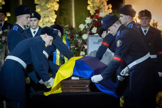 Ukrainian soldiers attend a farewell ceremony for State Secretary Yurii Lubkovych in Kyiv, Ukraine, Saturday, Jan. 21, 2023. Interior Minister Denys Monastyrsky, his Deputy Yevhen Yenin, State Secretary Yurii Lubkovych, national police official and the three crew members were killed in a helicopter crash on Wednesday in Kyiv suburbs of Brovary. (AP Photo/Efrem Lukatsky)