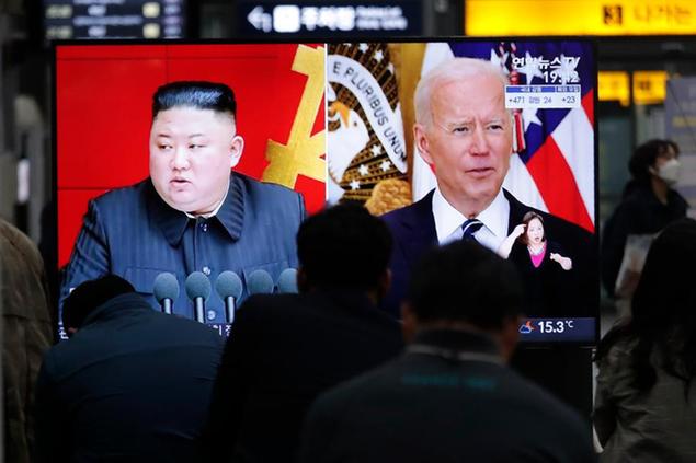 Commuters watch a TV showing a file image of North Korean leader Kim Jong Un and U.S. President Joe Biden during a news program at the Suseo Railway Station in Seoul, South Korea, Friday. March 26, 2021. North Korea on Friday confirmed it had tested a new guided missile, as Biden warned of consequences if Pyongyang escalates tensions amid stalled nuclear negotiations. (AP Photo/Ahn Young-joon)