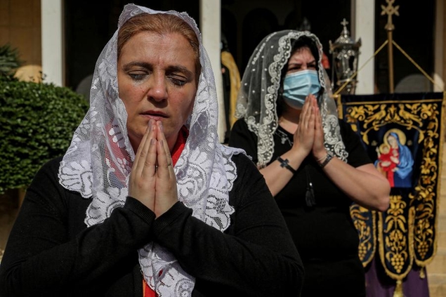 24 April 2021, Lebanon, Antelias: Lebanese Armenian women pray outside a memorial cemetery of Armenians who were executed by Ottoman Turks, during a memorial service held to mark the 106th anniversary of the Armenian Genocide that was carried out in 1915-1917 by the Ottoman Empire and its then ruling party, the Committee of Union and Progress, during World War I. US President Joe Biden is expected to recognize the massacre as an act of genocide. Photo by: Marwan Naamani/picture-alliance/dpa/AP Images