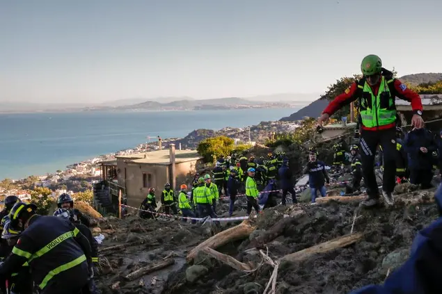 Rescuers work after heavy rainfall triggered landslides that collapsed buildings, in Casamicciola, on the southern Italian island of Ischia, Monday, Nov. 28, 2022. Authorities said that the landslide that early Saturday destroyed buildings and swept parked cars into the sea left at least eight people dead and more missing. (AP Photo/Salvatore Laporta)