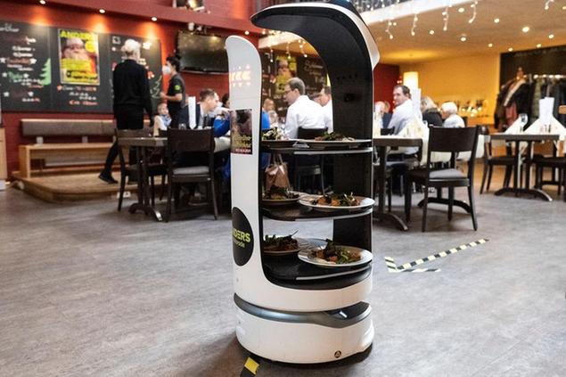 25 December 2021, Lower Saxony, Walsrode: Restaurant robot \\\"Paula\\\" moves starter plates through the dining room at Anders Hotel Walsrode. The robot supports the service staff in serving the Christmas menu. Photo by: Swen Pf'rtner/picture-alliance/dpa/AP Images