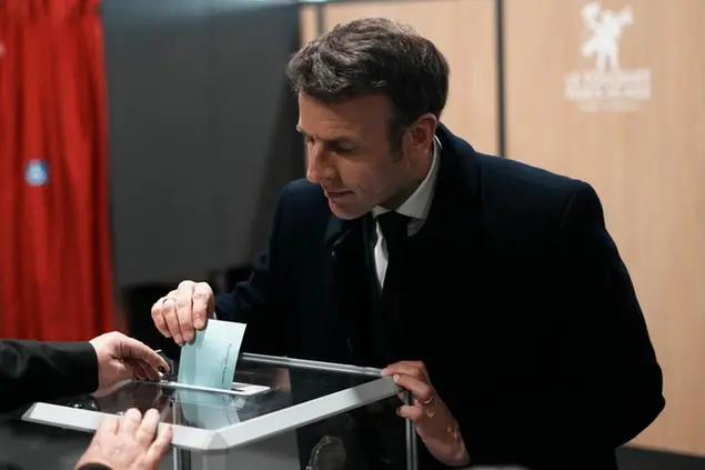French President and centrist presidential candidate for reelection Emmanuel Macron casts his ballot for the first round of the presidential election, Sunday, April 10, 2022 in Le Touquet, northern France. Polls opened across France for the first round of the country's presidential election, where up to 48 million eligible voters will be choosing between 12 candidates. President Emmanuel Macron is seeking a second five-year term, with a strong challenge from the far right. (AP Photo/Thibault Camus, Pool)