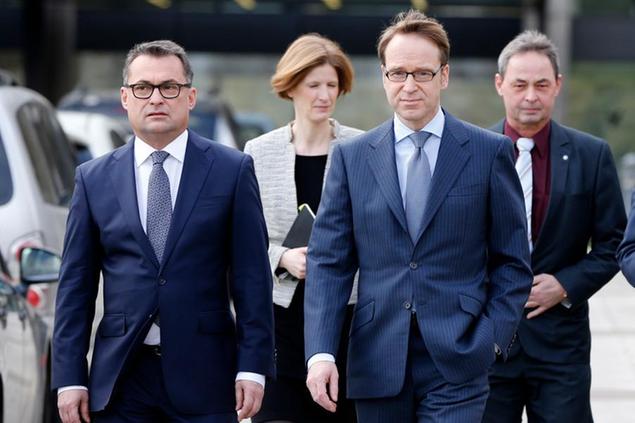 FILE -The President of the German Bundesbank Jens Weidmann , right, and then board member Joachim Nagel, left, on their way to the annual press conference in Frankfurt, Germany, Wednesday, Feb. 24, 2016. Germany's new government has chosen Joachim Nagel, an experienced central banker and former board member at Germany's state-owned development bank, to head the country's central bank, the finance minister said Monday. (AP Photo/Michael Probst,file)