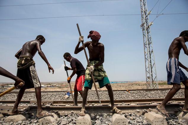 --FILE--African workers maintain and check the Addis Ababa\\u00E2\\u20AC\\u201CDjibouti railway during a trial run in Addis Ababa, Ethiopia, 28 September 2016. After four years' construction, the Addis Ababa\\u00E2\\u20AC\\u201CDjibouti railway, the longest electric railway in Africa, crossing Ethiopia and Djibouti, was officially opened on October 5, 2016. Africa's first cross-border electric railway was built by Chinese enterprises and the opening of the railway marks a significant milestone in the development of the two countries. (Imaginechina via AP Images)