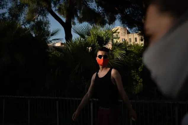 Piotr Grabarczyk, from Poland, walks at a park in Barcelona, Spain, Thursday, July 30, 2020. Grabarczyk and his boyfriend are starting over in Spain, a country that — unlike Poland — allows same-sex couples the right to marry and adopt children. Like them, many LGBT people are choosing to leave Poland amid rising homophobia promoted by President Andrzej Duda and other right-wing populist politicians in power. (AP Photo/Felipe Dana)