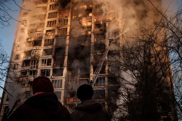 Ukrainian firefighters work in an apartment building after bombing in Kyiv, Ukraine, Tuesday, March 15, 2022. (AP Photo/Felipe Dana)