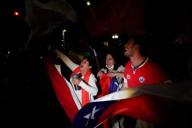 Opponents of the new Constitution cheer in the streets after listening to the results of a plebiscite on whether the new Constitution will replace the current Magna Carta imposed by a military dictatorship 41 years ago, in Santiago, Chile, Sunday, Sept. 4, 2022. (AP Photo/Matias Basualdo)