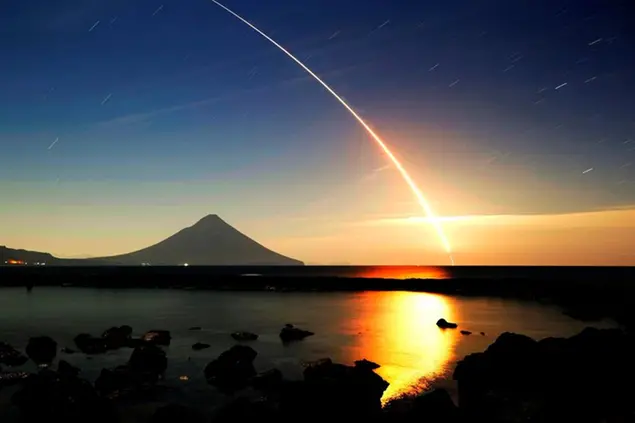 This four-minute exposure photo taken from Minamikyushu in Kagoshima Prefecture, southwestern Japan, shows the light trail left by an H-2A rocket carrying a British communications satellite following its launch from Tanegashima Space Center in the prefecture in the early hours of Dec. 23, 2021. (Kyodo via AP Images) ==Kyodo
