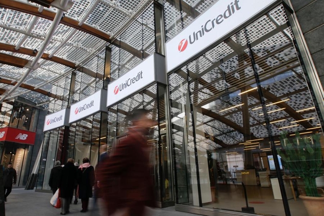 FILE - In this file photo dated Tuesday, Dec. 13, 2016, the entrance of the UniCredit tower at the Porta Nuova business district in Milan, Italy. Italian bank UniCredit said Thursday Nov. 8, 2018, that one-off provisions to cover any settlement for alleged U.S. sanctions violations in Iran and a write-down on its Turkish unit dropped third-quarter profits by 99 percent. (AP Photo/Luca Bruno, FILE)