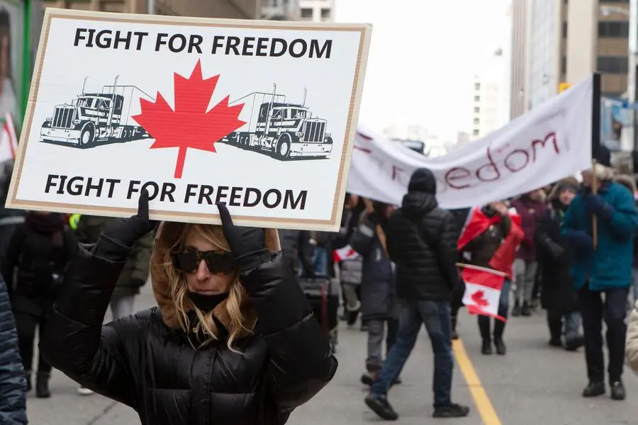 Protesters march in Toronto to voice their opposition to COVID-19 vaccine mandates on Saturday, Feb. 12, 2022. The demonstrations at the Ambassador Bridge, downtown Ottawa and elsewhere have targeted vaccine mandates and other coronavirus restrictions and vented fury toward Prime Minister Justin Trudeau, who has called the protesters a “fringe” of Canadian society. (Chris Young /The Canadian Press via AP)