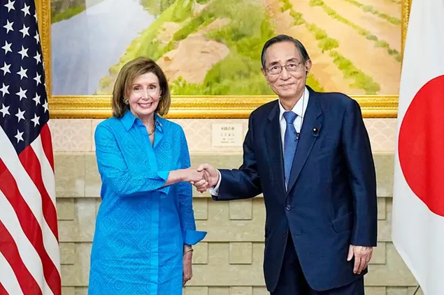 U.S. House Speaker Nancy Pelosi (L) shakes hands with her Japanese counterpart Hiroyuki Hosoda before their talks in Tokyo on Aug. 5, 2022. (Kyodo via AP Images) ==Kyodo