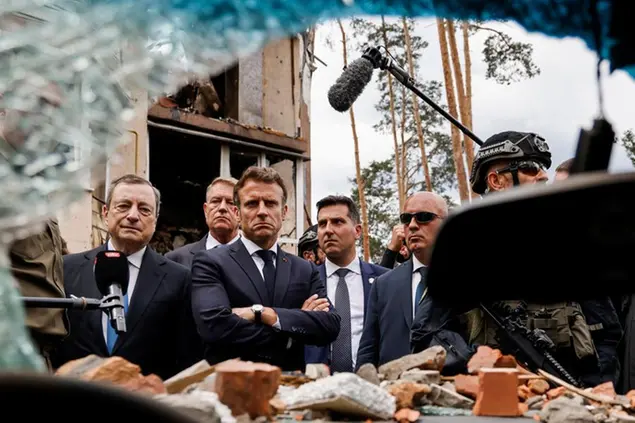 Italian Prime Minister Mario Draghi, left, and French President Emmanuel Macron examine debris as they visit Irpin, outside Kyiv, Thursday, June 16, 2022. The leaders of France, Germany, Italy and Romania arrived in Kyiv on Thursday in a show of collective European support for the Ukrainian people as they resist Russia's invasion, marking the highest-profile visit to Ukraine's capital since Russia invaded its neighbor. (Ludovic Marin/ Pool Photo via AP)