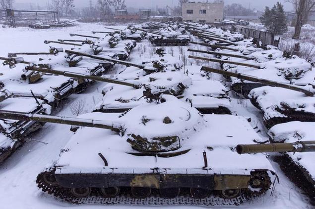 Old T-64 tanks covered by snow stands at the depot site at the Tank Repair Plant in Kharkiv, Ukraine, Monday, Jan. 31, 2022. Kharkiv is just 40 kilometers (25 miles) from some of the tens of thousands of Russian troops massed at the border. It is also one of the country's industrial centers and includes two facilities that restore old Soviet-era tanks or build new ones. If Russia invades, some of the city's 1 million-plus people say they are prepared to abandon their ordinary civilian lives and wage a guerilla campaign against one of the world's greatest military powers. (AP Photo/Evgeniy Maloletka)