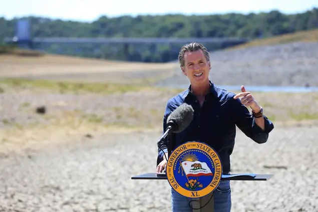 FILE â€” In this April 21, 2021, file photo California Gov. Gavin Newsom speaks at a news conference in the parched basin of Lake Mendocino in Ukiah, Calif., where he announced he would proclaim a drought emergency for Mendocino and Sonoma counties. On Thursday July 8, 2021, Newsom asked people to voluntarily reduce their water use by 15% in the middle of the drought. He also added nine more counties to the state's emergency proclamation. (Kent Porter/The Press Democrat via AP, File)