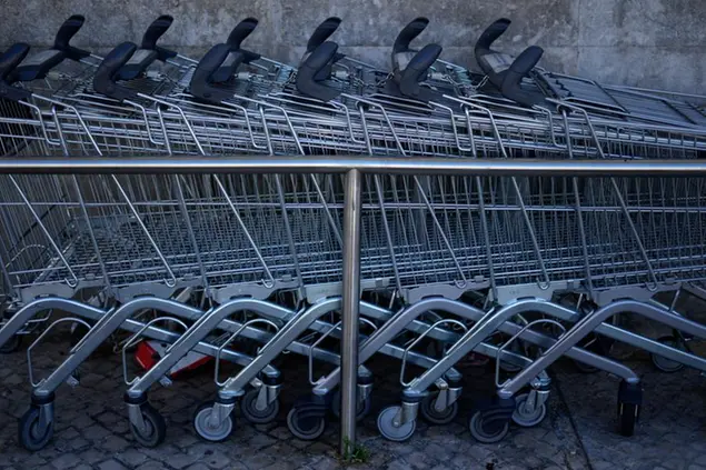 Shopping carts are parked outside a supermarket, in Lisbon, Monday, Sept. 5, 2022. The Portuguese government is holding a special cabinet meeting on Monday to discuss and approve a special aid package intended to help families cope with an increasing cost of living. Inflation in Portugal stabilized at about 9% in August, roughly the same as in July. (AP Photo/Armando Franca)