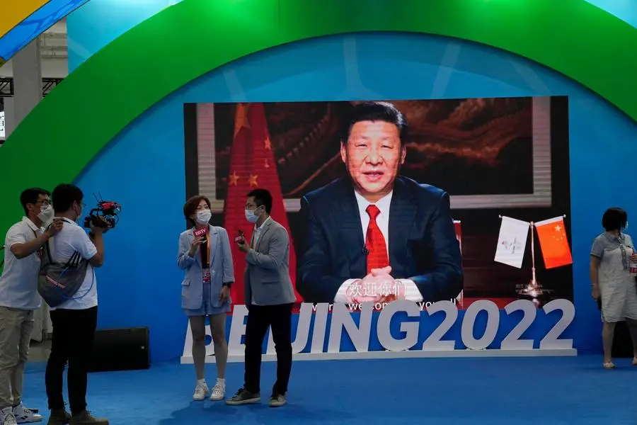 Chinese President Xi Jinping is seen on a screen at a booth promoting winter sports ahead of the 2022 Beijing Winter Olympics during the China International Fair for Trade in Services (CIFTIS) in Beijing, China on Sunday, Sept. 5, 2021. (AP Photo/Ng Han Guan)