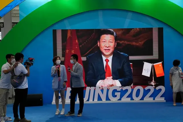 Chinese President Xi Jinping is seen on a screen at a booth promoting winter sports ahead of the 2022 Beijing Winter Olympics during the China International Fair for Trade in Services (CIFTIS) in Beijing, China on Sunday, Sept. 5, 2021. (AP Photo/Ng Han Guan)