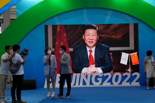 Chinese President Xi Jinping is seen on a screen at a booth promoting winter sports ahead of the 2022 Beijing Winter Olympics during the China International Fair for Trade in Services (CIFTIS) in Beijing, China on Sunday, Sept. 5, 2021. (AP Photo/Ng Han Guan)