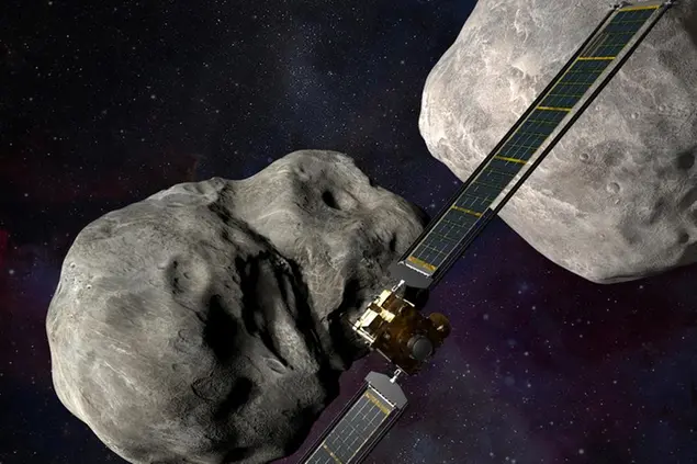 This illustration made available by Johns Hopkins APL and NASA depicts NASA's DART probe, center, and Italian Space Agency's (ASI) LICIACube, bottom right, at the Didymos system before impact with the asteroid Dimorphos, left. DART is expected to zero in on the asteroid Monday, Sept. 26, 2022, intent on slamming it head-on at 14,000 mph. The impact should be just enough to nudge the asteroid into a slightly tighter orbit around its companion space rock. (Steve Gribben/Johns Hopkins APL/NASA via AP)