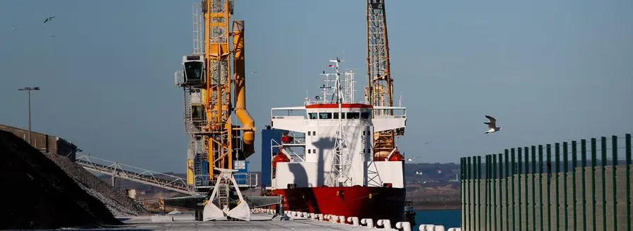 A Russian flag cargo ship docks in the port of Boulogne-sur-Mer, northern France, Saturday, Feb. 26, 2022 . French officials say marines patrolling the English Channel area have intercepted a cargo ship sailing under the Russian flag and escorted it to the port of Boulogne-Sur-Mer for an investigation. The interception of the ship, carrying cars, early Saturday was triggered by financial sanctions levied days ago against Russia for its invasion of the Ukraine. (AP Photo/Michel Spingler)