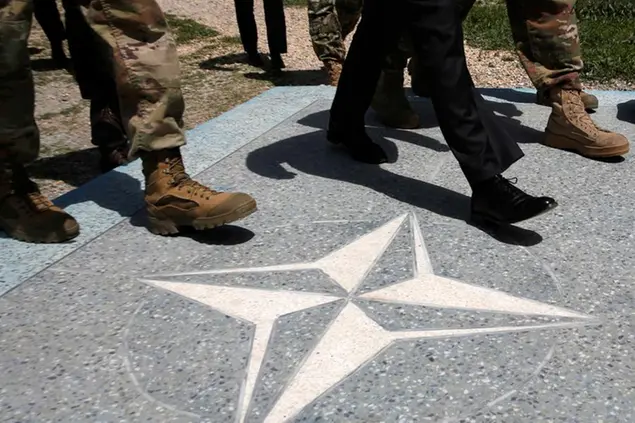 U.S. Defense Secretary James Mattis, in black dress shoes, walks with U.S. Army leaders across a NATO logo as he arrives at Resolute Support headquarters, in Kabul, Afghanistan Monday, April 24, 2017. (Jonathan Ernst/Pool Photo via AP)