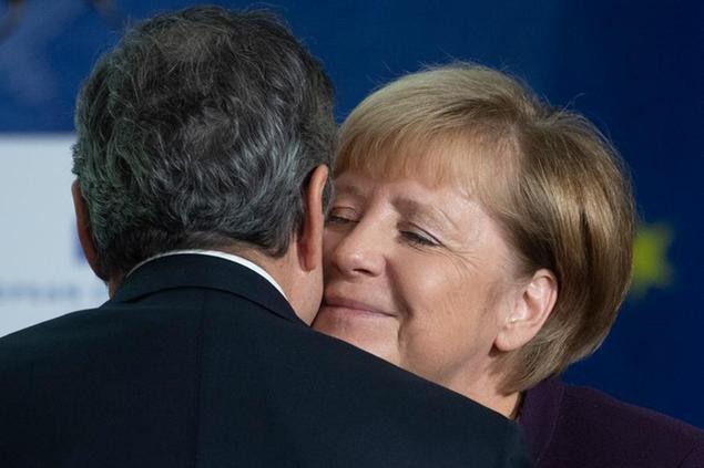 28 October 2019, Hessen, Frankfurt/Main: Chancellor Angela Merkel (CDU, r) embraces outgoing ECB President Mario Draghi at a ceremony marking the change at the head of the ECB. Photo by: Boris Roessler/picture-alliance/dpa/AP Images