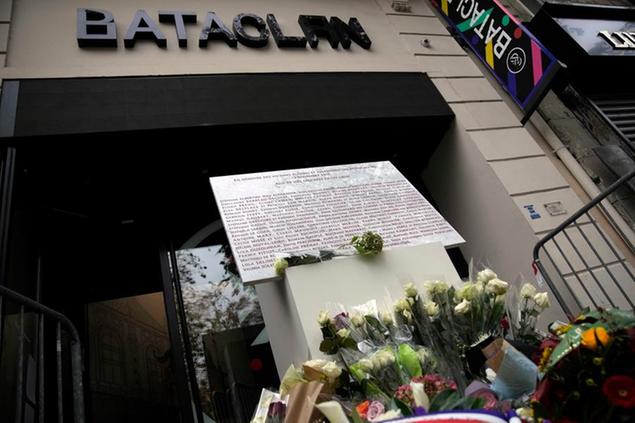 A commemorative plaque and flowers are pictured in front of the entrance of the Bataclan concert hall after a ceremony marking the sixth anniversary of the Paris attacks of November 2015 in which 130 people were killed, Saturday, Nov. 13, 2021. (AP Photo/Christophe Ena)