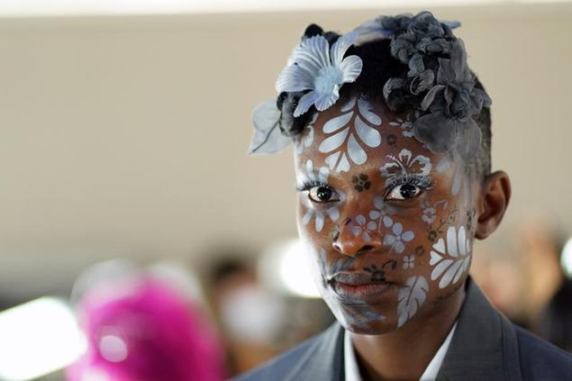 A model appears backstage in preparation for the Thom Browne fashion show during New York Fashion Week at The Shed, on Saturday, Sept. 11, 2021, in New York. (Photo by Charles Sykes/Invision/AP)