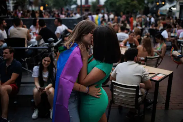 Two girls kiss during the first day of the Madrid Pride festivities, in the Chueca neighborhood, on July 1, 2022, in Madrid (Spain). MADO'22, the big LGBTIQ Pride party, will be held again in the capital of Madrid from today until next Sunday, July 10 and begins with Chueca's Pride in which acts and events have filled the premises of the Chueca neighborhood, a reference point for the LGTBIQ collective. The central event of the Pride is the LGTBIQ Pride State Demonstration, which will take place next Saturday, July 9, under the slogan \\\"Facing hate: Visibility, Pride and Resilience\\\". 01 JULY 2022 Alejandro Mart\\u00C3\\u00ADnez V\\u00C3\\u00A9lez / Europa Press 07/01/2022 (Europa Press via AP)