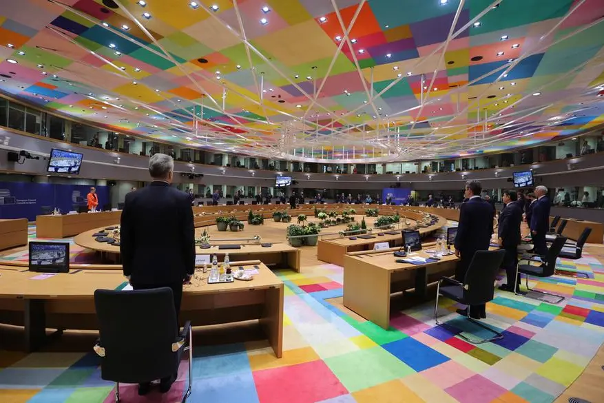 European Union heads of state stand for a moment to remember late French President Valery Giscard d'Estaing during a round table meeting at an EU summit at the European Council building in Brussels, Thursday, Dec. 10, 2020. European Union leaders meet for a year-end summit that will address anything from climate, sanctions against Turkey to budget and virus recovery plans. Brexit will be discussed on the sidelines. (AP Photo/Olivier Matthys, Pool)