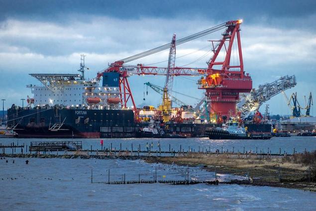FILE - A tugboats get into position on the Russian pipe-laying vessel \\\"Fortuna\\\", being used for construction work on the German-Russian Nord Stream 2 gas pipeline in the Baltic Sea, in the port of Wismar, Germany, Jan 14, 2021. Fears are rising about what would happen to Europe\\u00E2\\u20AC\\u2122s energy supply if Russia were to invade Ukraine and then shut off its natural gas in retaliation for U.S. and European sanctions. (Jens Buettner/dpa via AP, File)