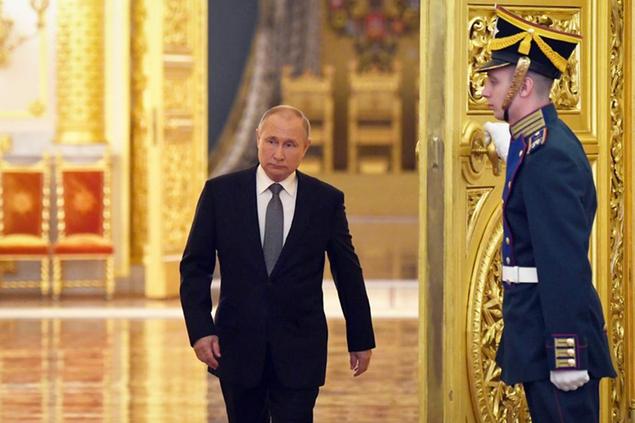 Russian President Vladimir Putin enters a hall during a meeting with graduates of the country's higher military schools at the Kremlin in Moscow, Russia, Tuesday, June 21, 2022. (Kirill Kallinikov, Sputnik, Kremlin Pool Photo via AP)
