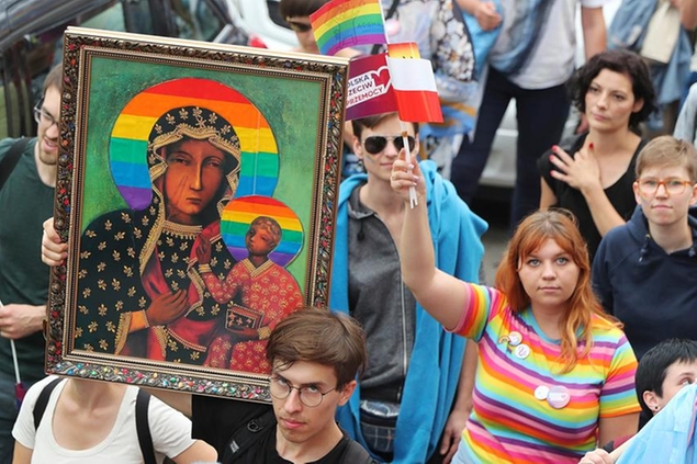 In this Aug. 10, 2019, photo, people take part in a gay pride parade holding up an image of Madonna and Baby Jesus that has offended many Catholics in Plock, Poland. The image was made by an activist in protest. (AP Photo/Czarek Sokolowski)